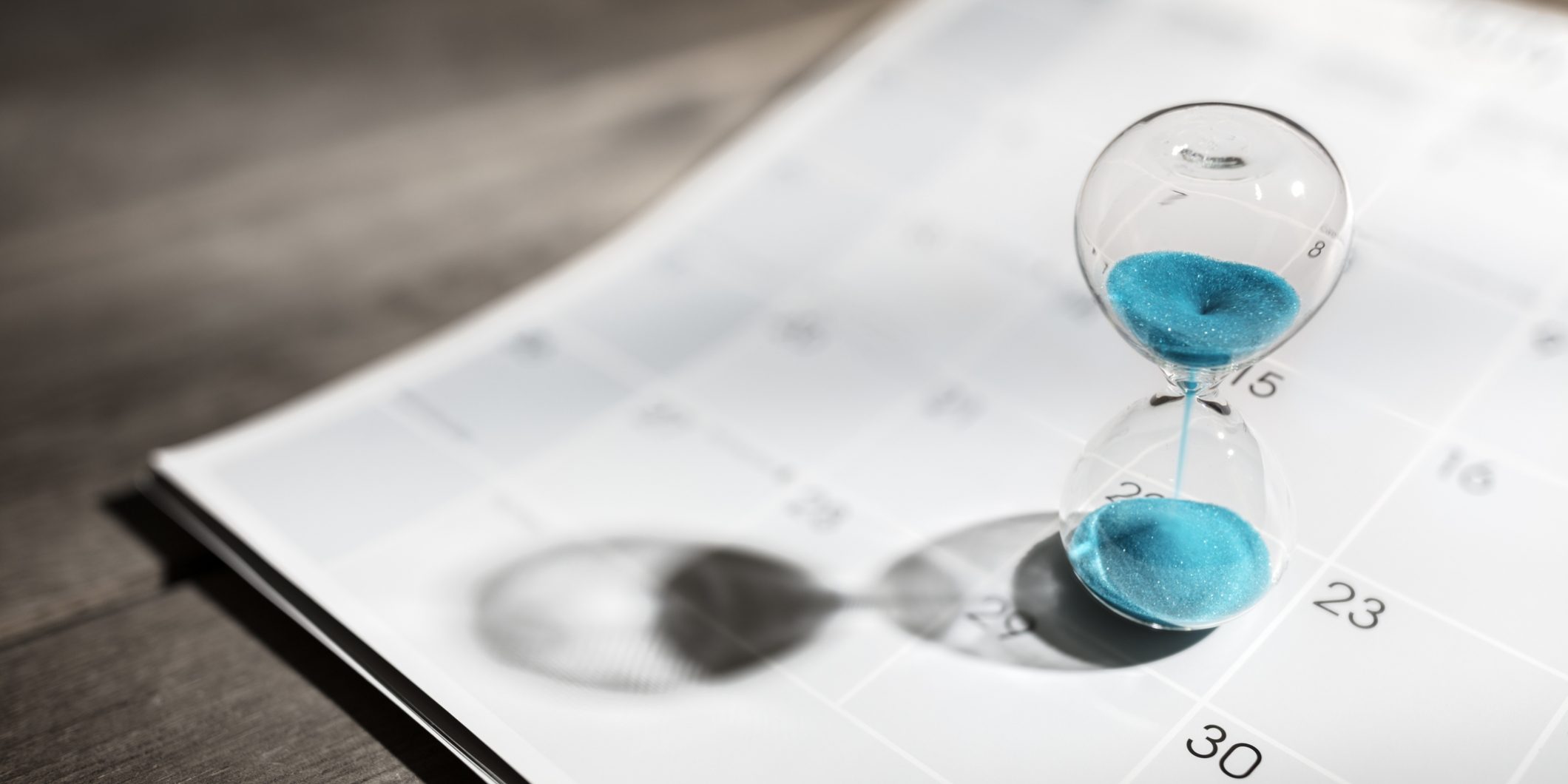 Hourglass on calendar appointment date, schedule and deadline