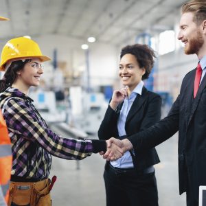 Quality inspectors shaking hands with workers