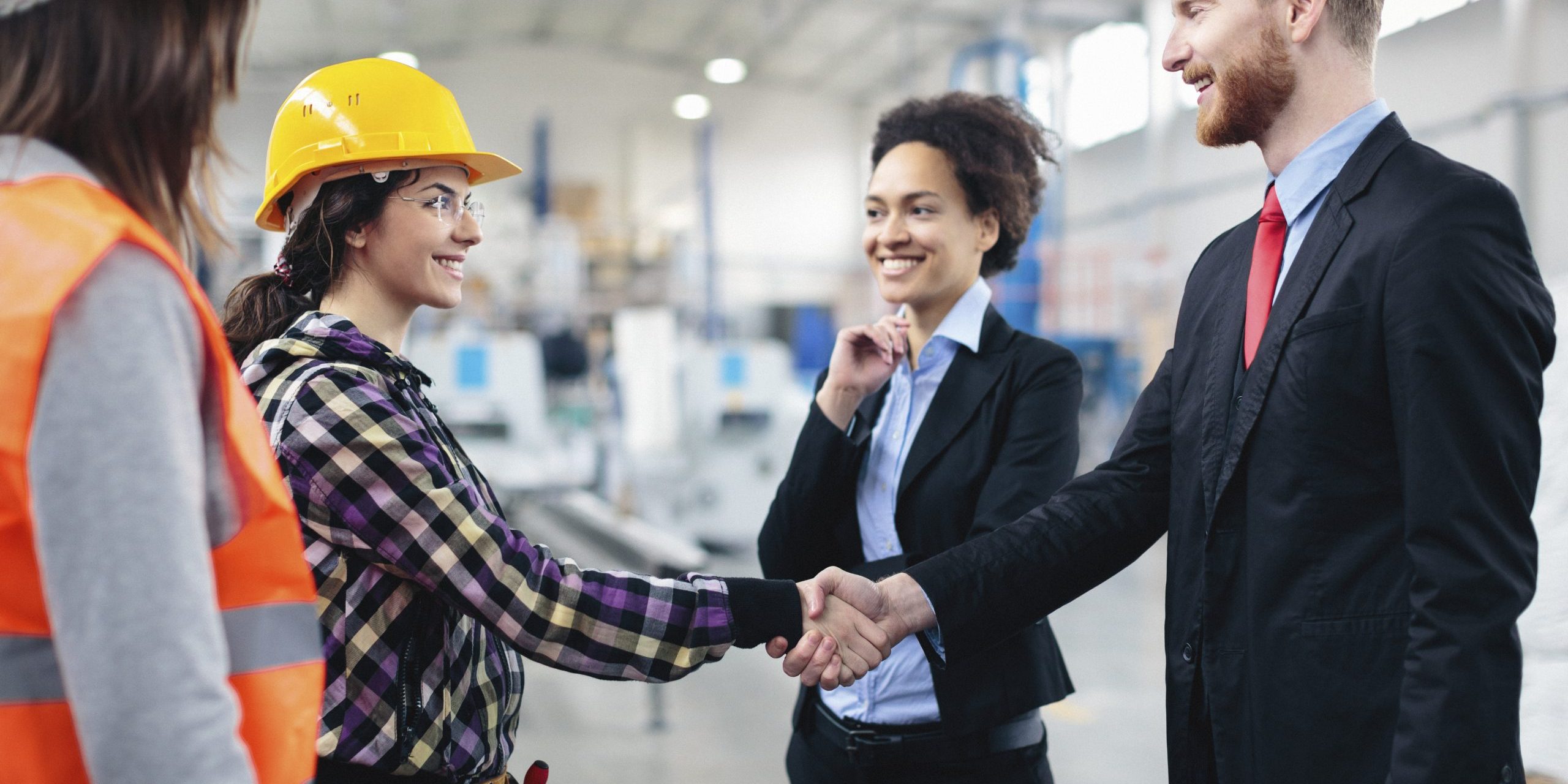 Quality inspectors shaking hands with workers