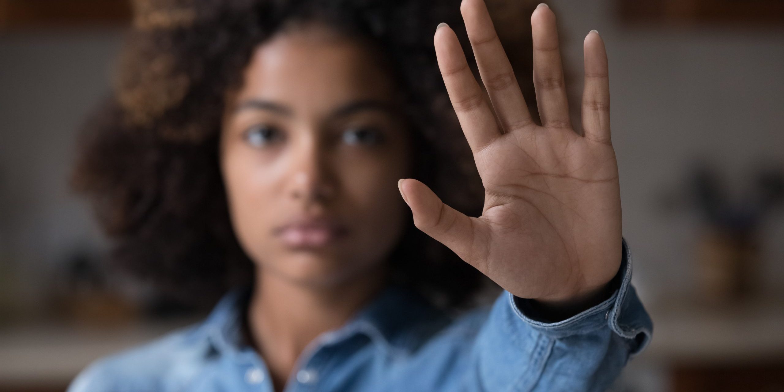 Close up African woman outstretched hand, makes stop gesture