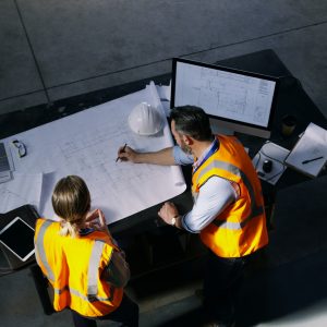 More Contractors Increase Deductibles to Reduce Insurance Premiums High angle shot of two engineers going over a blueprint together in an industrial place of work